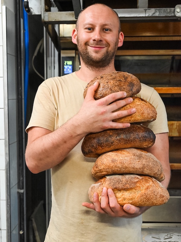 piekarz Zmączeni w Krakowie trzymający chleb