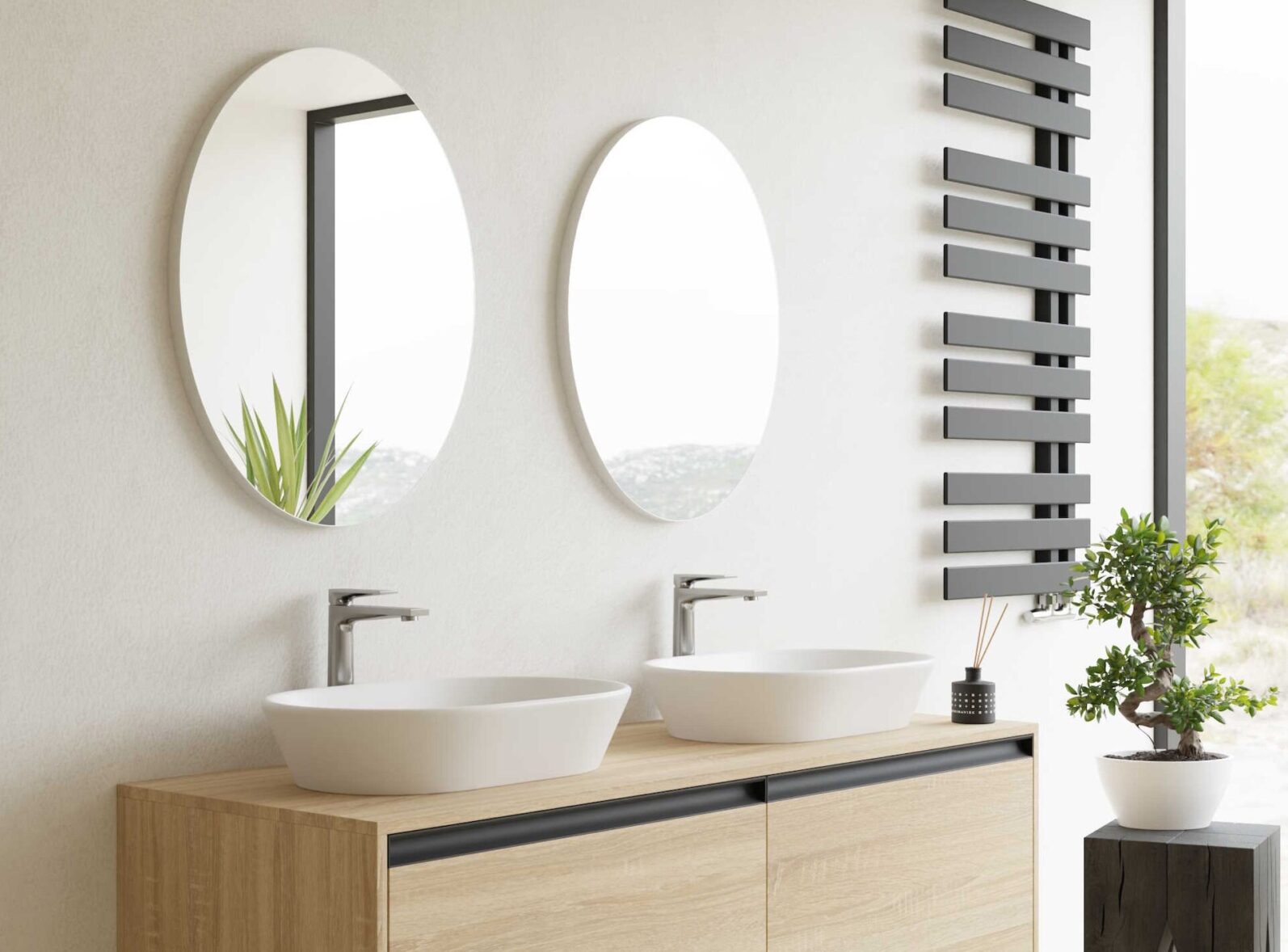 dwie umywalki z okrągłymi lustrami